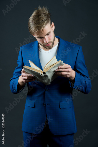 Lawyer bearded concentrated looking at book read organizer dark background. Business man formal suit learn details from notepad. Business literature influence on modern business theory and practice