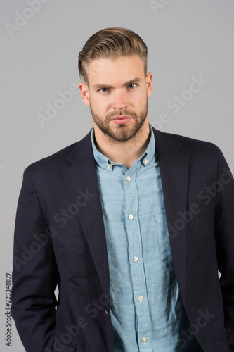 Man entrepreneur bearded with perfect hairstyle grey background. Simple hacks make hairstyle better. Use right product styling hair. Confident metrosexual with tidy hairstyle. Barber hairstyle tips