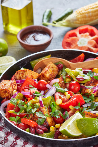 Tasty warm mexican salad with fried tofu, vertical