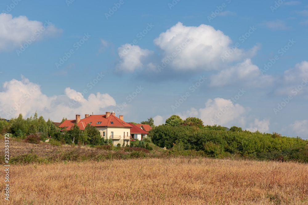  Early autumn rural landscape, blue sky, field, beautiful big hause, Poland