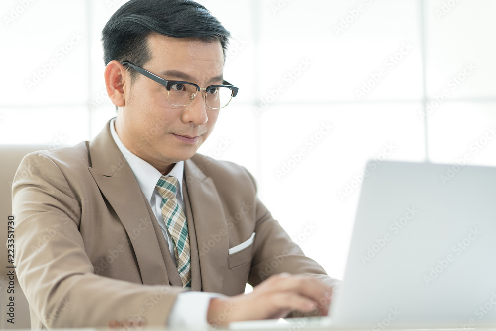 Experienced businessman or lawyer sitting work on laptop computer in the office. Experienced businessman or lawyer sitting work on laptop computer in the office.