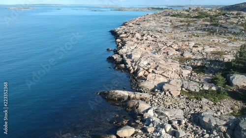 Aerial drone reveal shot of a rocky ocean coast line on the west coast of Sweden in Bohuslän outside of Gothenburg. photo