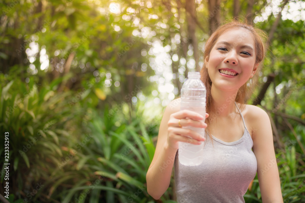 Portrait of Fresh Asian woman drinking some water after exercise at park. Portrait of Fresh Asian woman drinking some water after exercise at park.
