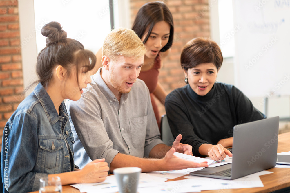 Fototapeta premium Colleagues excited about the earnings they make.