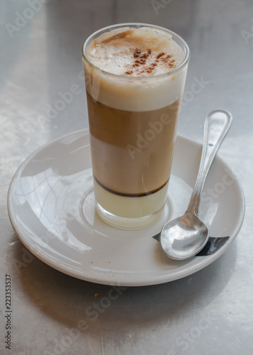 Fototapeta Naklejka Na Ścianę i Meble -  Coffee with milk and  liqueur on crystal glass with some cinnamon