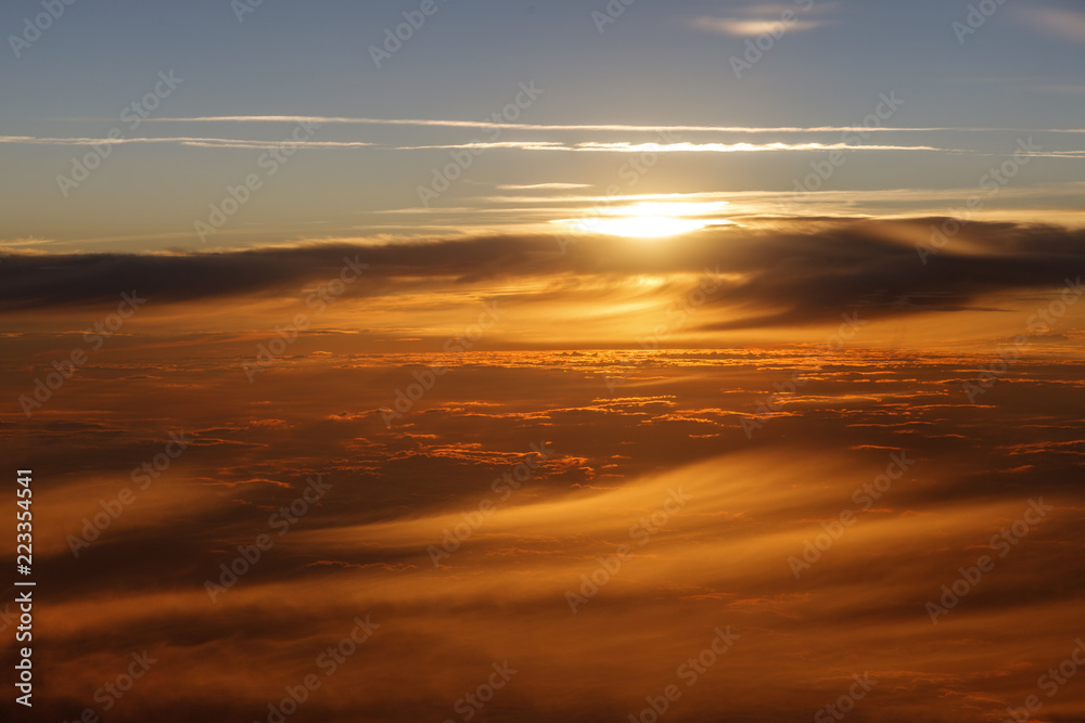 Clouds view from the airplane, Flying over the evening timelapse clouds with the late sun. Flight through moving cloudscape with beautiful sun rays. Traveling by air. Perfect for cinema, background