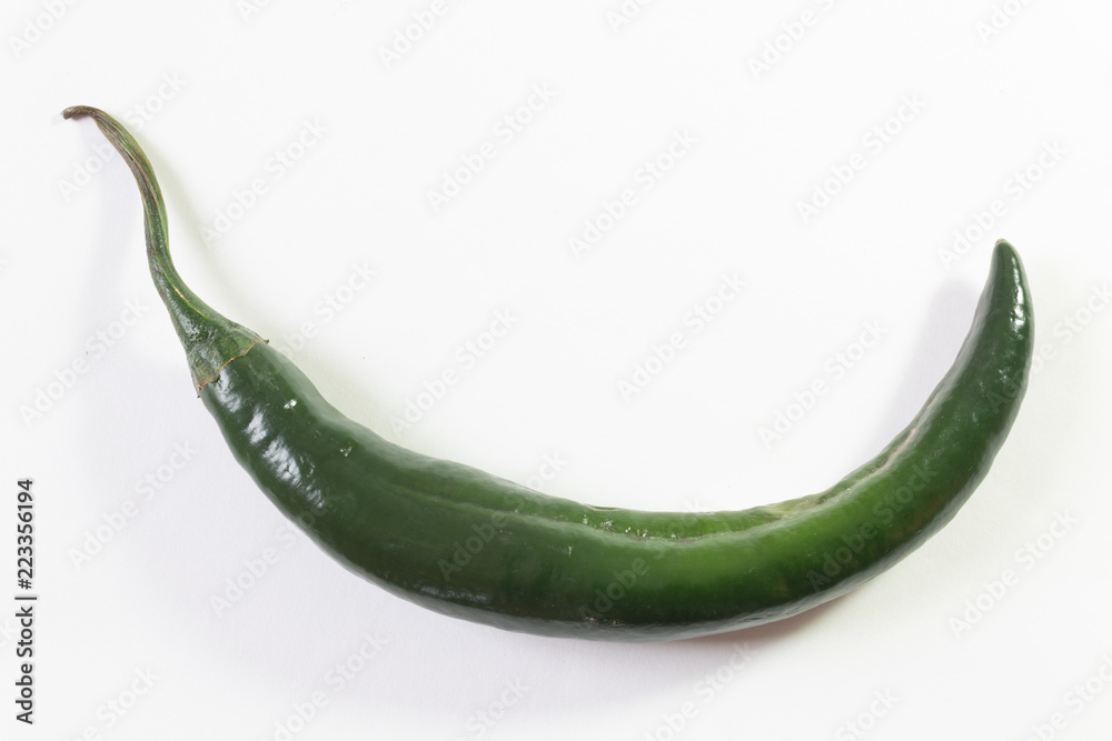 Single curved chilaca pepper, ample copy space, isolated on white, horizontal aspect Single curved chilaca pepper, ample copy space, isolated on white, horizontal aspect