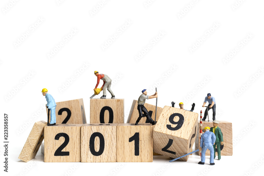 Miniature worker team painting number 2019 on white background , Happy new year 2019 concept