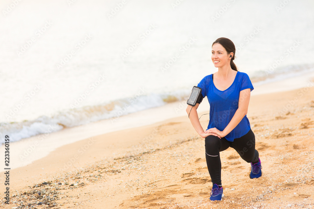 woman doing stretch exercises on the sea beach woman doing stretch exercises on the sea beach