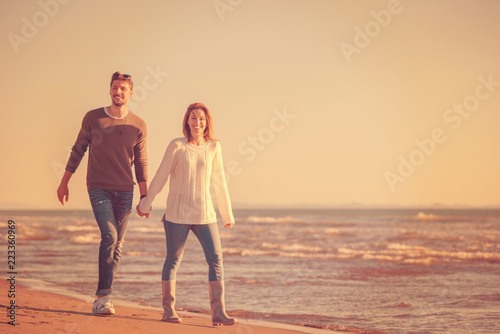 Loving young couple on a beach at autumn sunny day