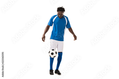sportive african american man in soccer uniform playing with ball isolated on white