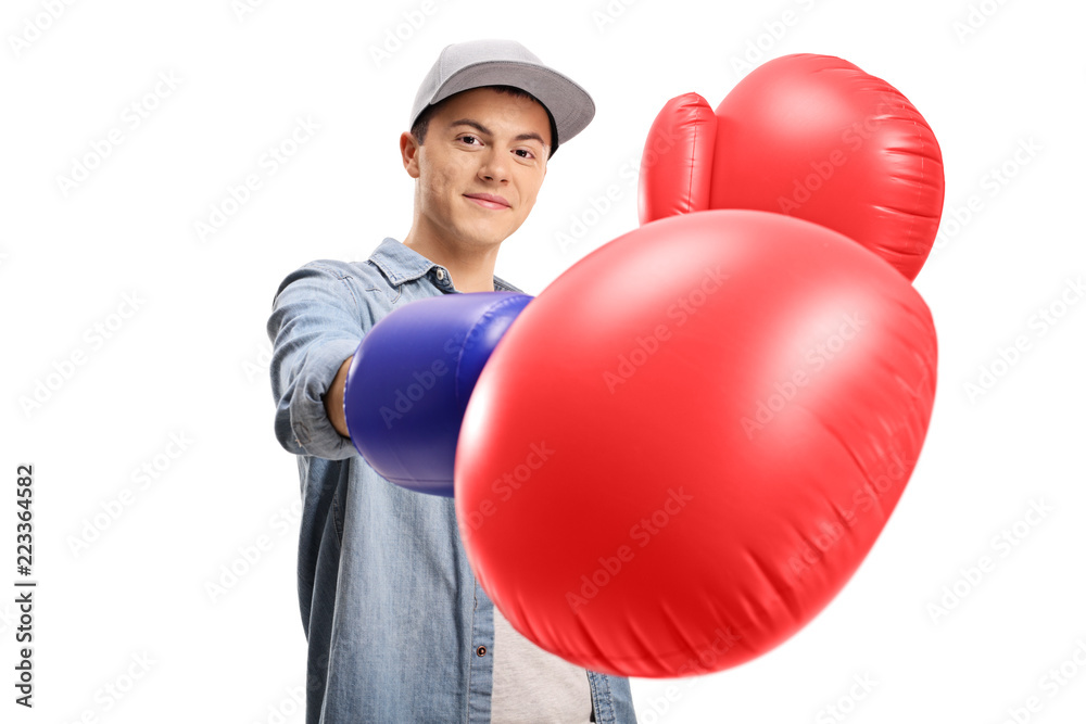 Teenage boy wearing a pair of big boxing gloves Teenage boy wearing a pair of big boxing gloves