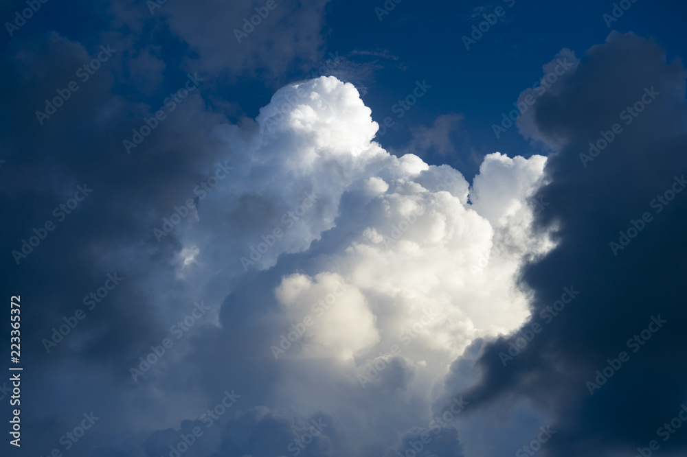 Abstract view of dramatic light and dark puffy summer thunderstorm clouds Abstract view of dramatic light and dark puffy summer thunderstorm clouds