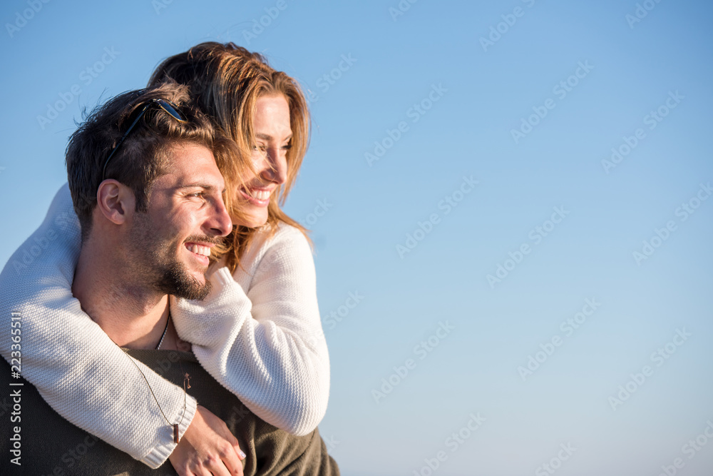 couple having fun at beach during autumn couple having fun at beach during autumn