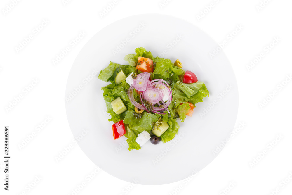 Greek salad with feta, olives, lettuce, red onion, cucumber, tomato, bell pepper, pesto on plate, white isolated background, view from above, for the menu, restaurant bar cafe Greek salad with feta, olives, lettuce, red onion, cucumber, tomato, bell pepper, pesto on plate, white isolated background, view from above, for the menu, restaurant bar cafe