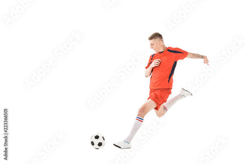 Fototapeta Naklejka Na Ścianę i Meble -  full length view of young sportsman playing soccer isolated on white