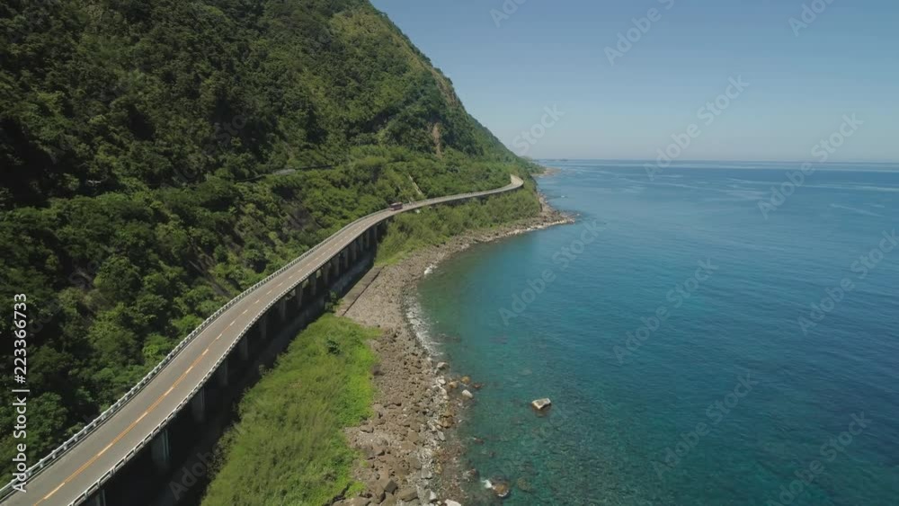 Aerial view of Patapat viaduct in the coast of Pagudpud, Ilocos Norte. Highway with bridge by coast sea near the mountains. Philippines, Luzon.