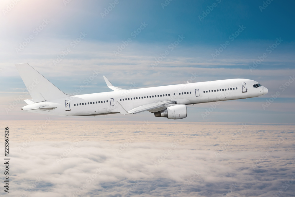 Passenger airplane fly on a hight above clouds and blue sky. Passenger airplane fly on a hight above clouds and blue sky.