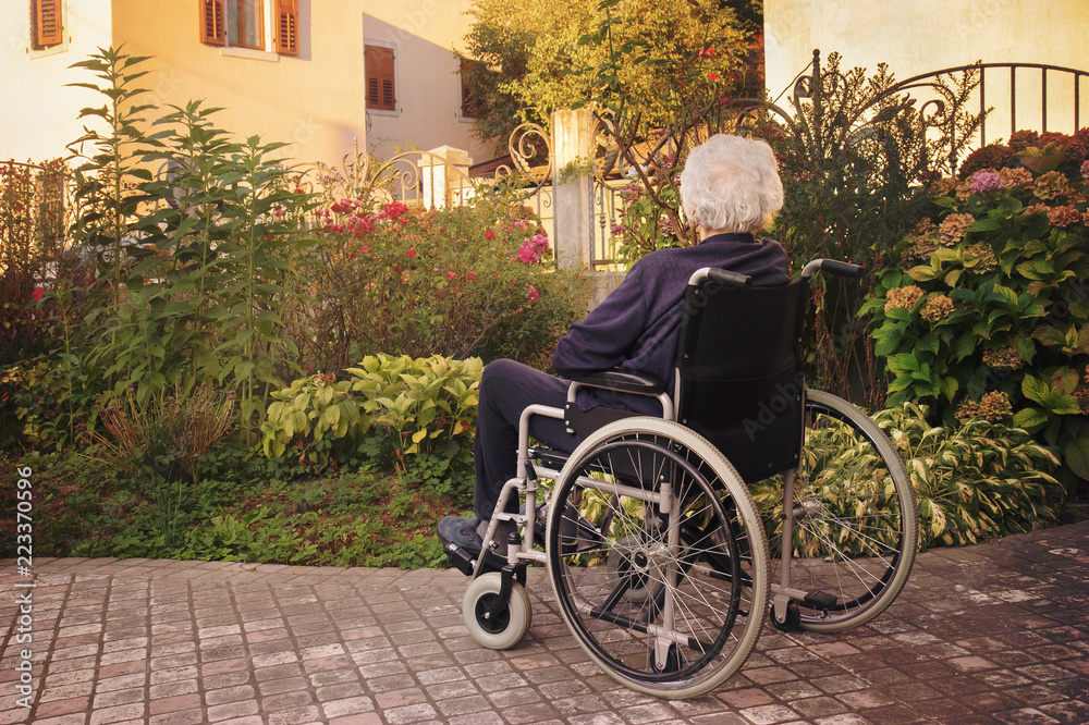 disabled old woman on wheelchair. Elderly woman suffering from dementia