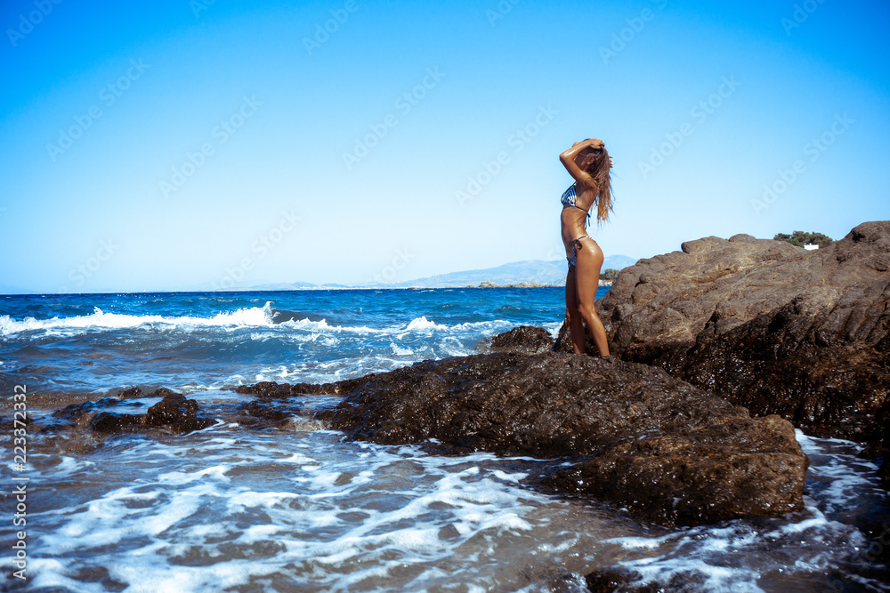 sexy girl on the rocks by the sea