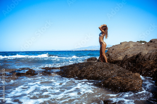 sexy girl on the rocks by the sea