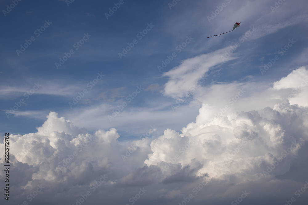 kite and Cumulus clouds and sun in the sky kite and Cumulus clouds and sun in the sky