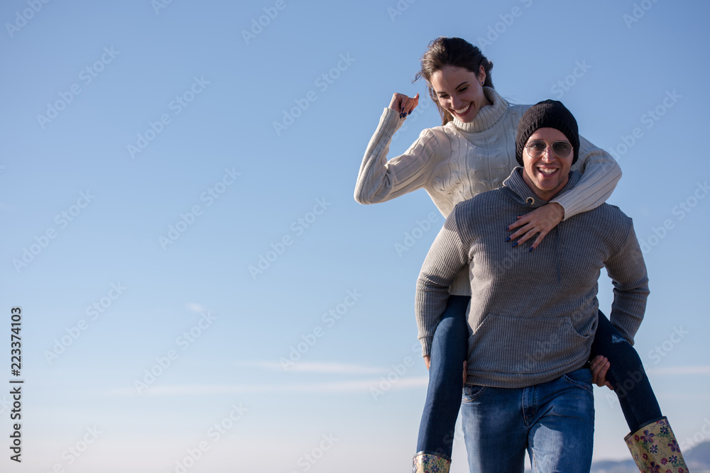 couple having fun at beach during autumn couple having fun at beach during autumn