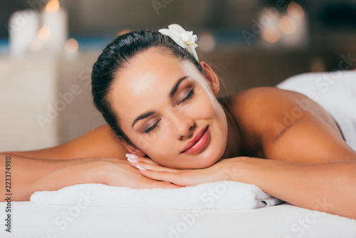 happy woman relaxing at massage salon