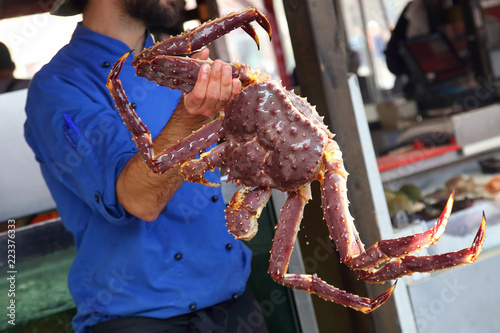 Cook holding a large crab