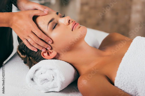young woman relaxing and having face massage