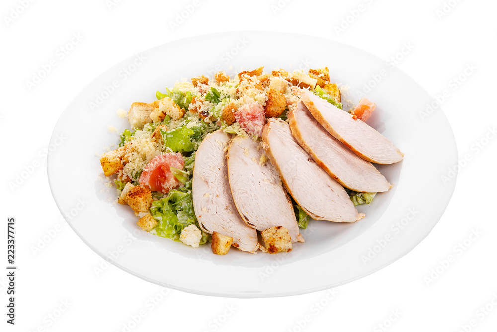 Caesar salad with slices of chicken breast, rusks, tomato, lettuce, cheese on plate, white isolated background Side view. For the menu, restaurant, bar, cafe Caesar salad with slices of chicken breast, rusks, tomato, lettuce, cheese on plate, white isolated background Side view. For the menu, restaurant, bar, cafe