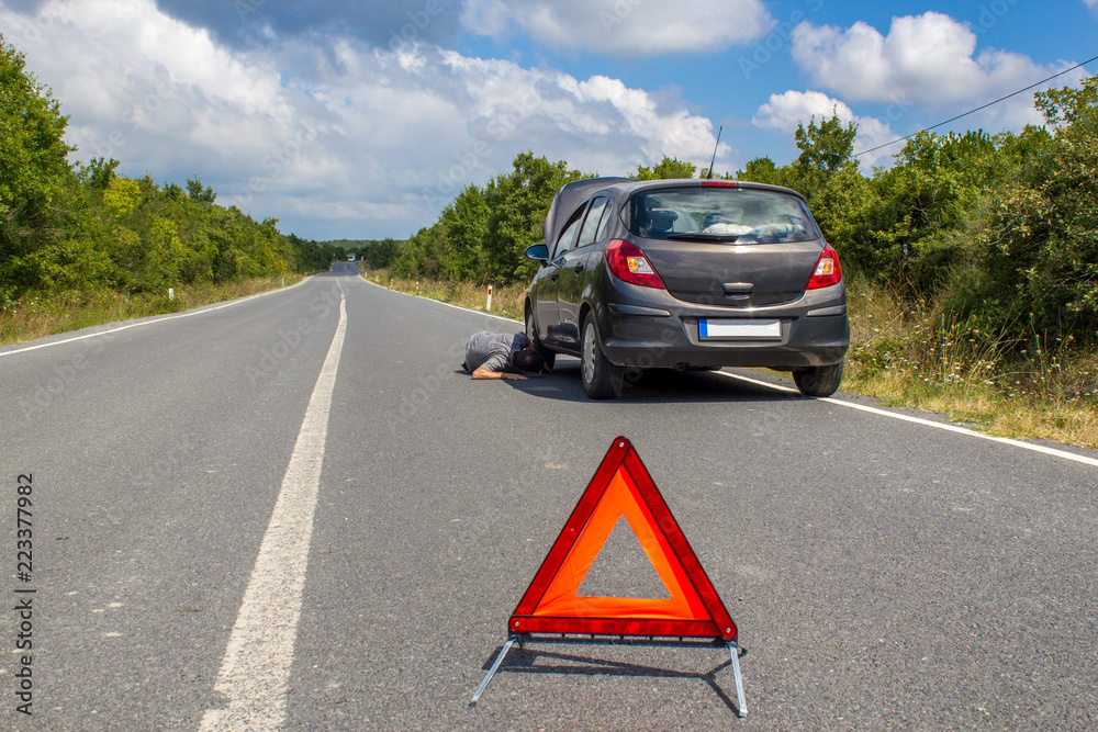 Car malfunction on countryside. Car waiting for help on the road. Car breakdown. Man with car breakdown. Waiting for roadside assistance Car malfunction on countryside. Car waiting for help on the road. Car breakdown. Man with car breakdown. Waiting for roadside assistance