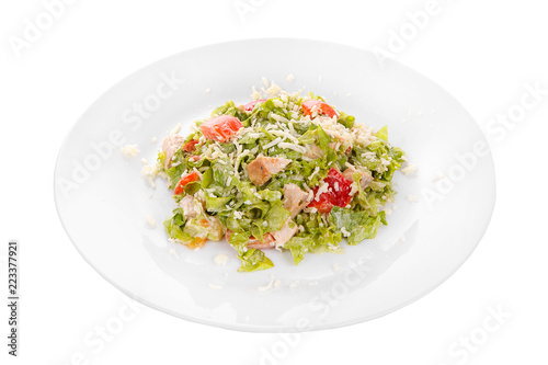 Caesar salad with pieces of chicken breast, rusks, tomato, lettuce, cheese on plate, white isolated background Side view. For the menu, restaurant, bar, cafe