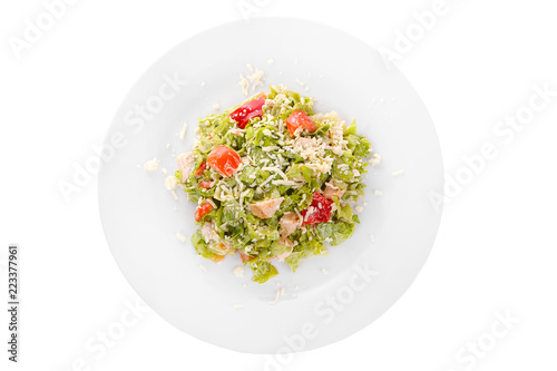 Caesar salad with pieces of chicken breast, rusks, tomato, lettuce, cheese on plate, white isolated background, view from above, for the menu, restaurant, bar, cafe