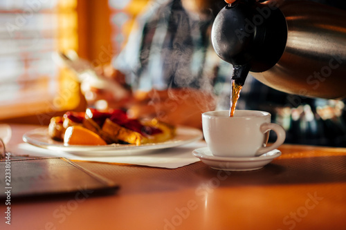 Waitress Pouring Fresh Coffee At A Classic Breakfast Diner