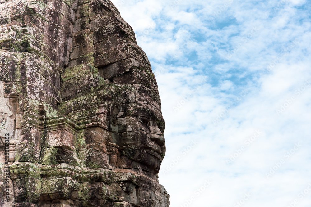 Face carved into stone of the ancient Bayan Temple at Angkor Wat, Cambodia.