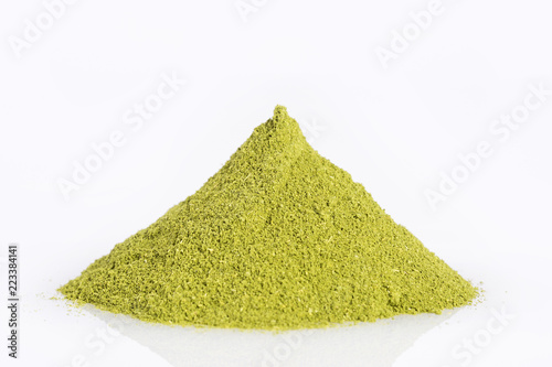 Natural sweetener in powder from stevia plant - Stevia rebaudiana. White background photo