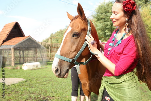 Beautiful gypsy woman with a horse