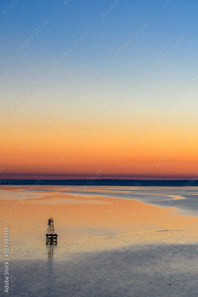 Sunrise and buoy on Mobile Bay