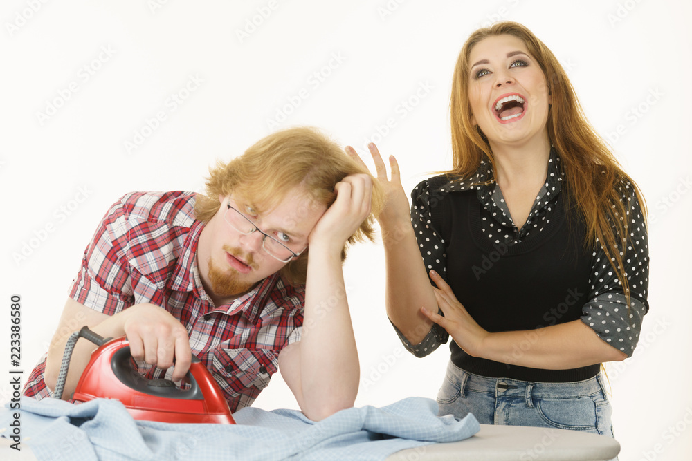 Happy woman and bored man ironing clothes Happy woman and bored man ironing clothes