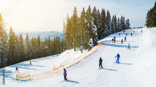 Winter holidays in the mountains. Mountain-skiing resort in the Carpathians.several skiers on a snowy road