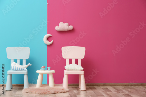 Stylish children's room interior with toys and new furniture, space for text