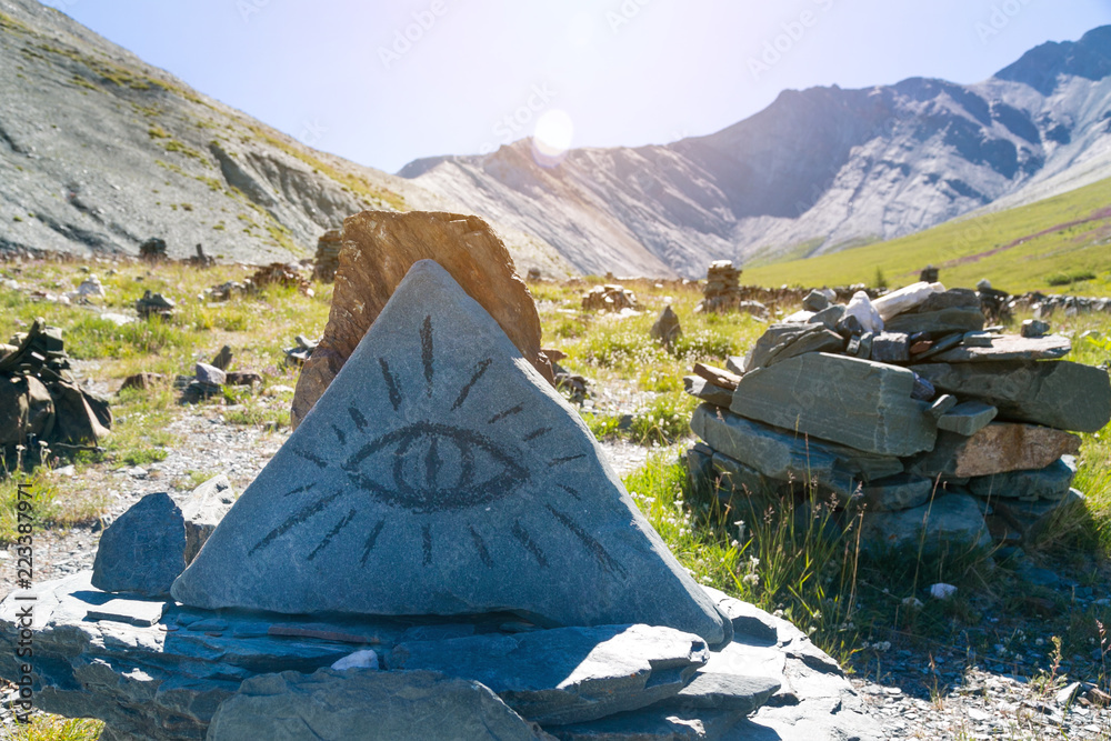 Triangular magic magical stone. Stone symbol of worship of the gods, paganism.