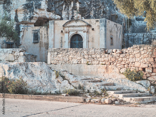 Shot of the Cava Santa main building, a religious ancient building made of stone in an old cave. Rosilini, Siracusa, Italy photo