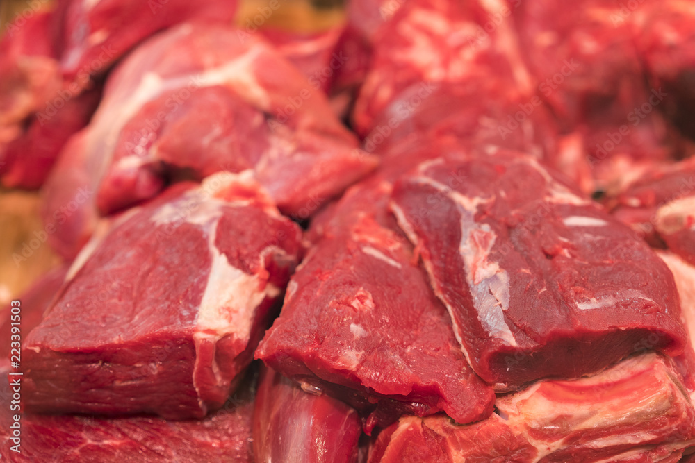 Large piece of red fresh meat on the counter. Tenderloin, steak and ingredients for cooking meat dishes. Meat on the counter in a black box. Soft focus