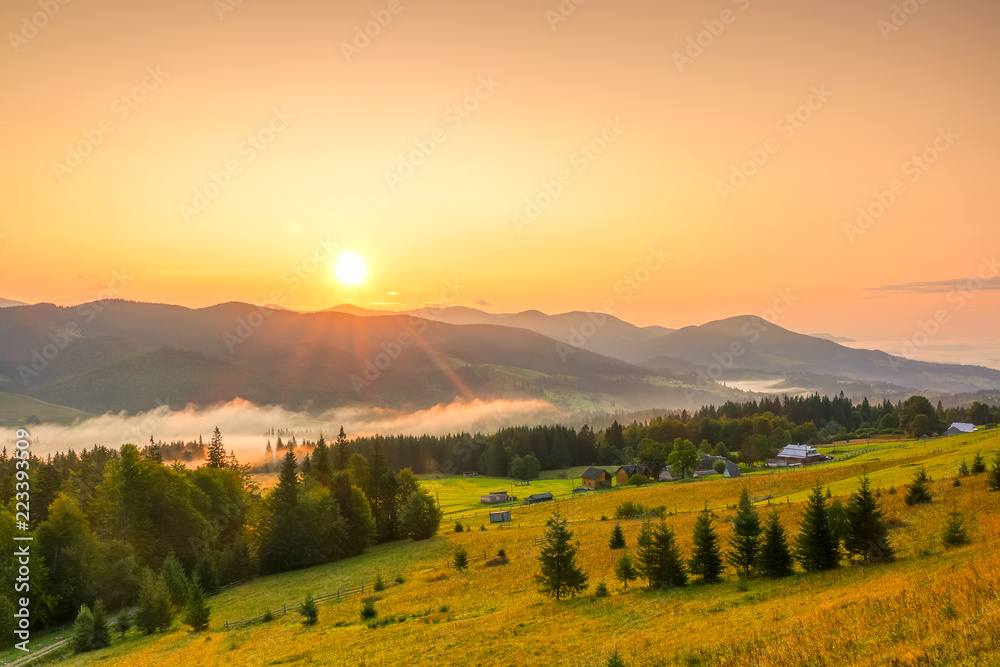 Sunrise over the Mountains and Fog in the Valley
