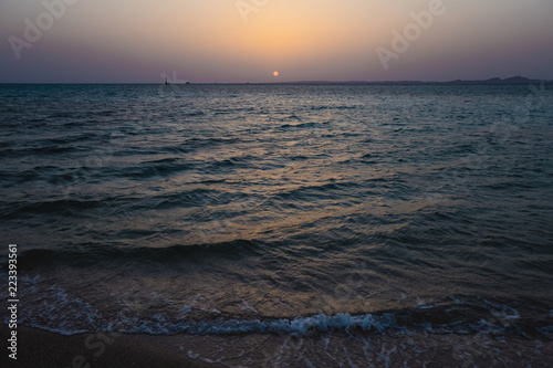 Beautiful sea water and blue sky during sunset or sunrise at sandy tropical beach. Horizontal color photography.