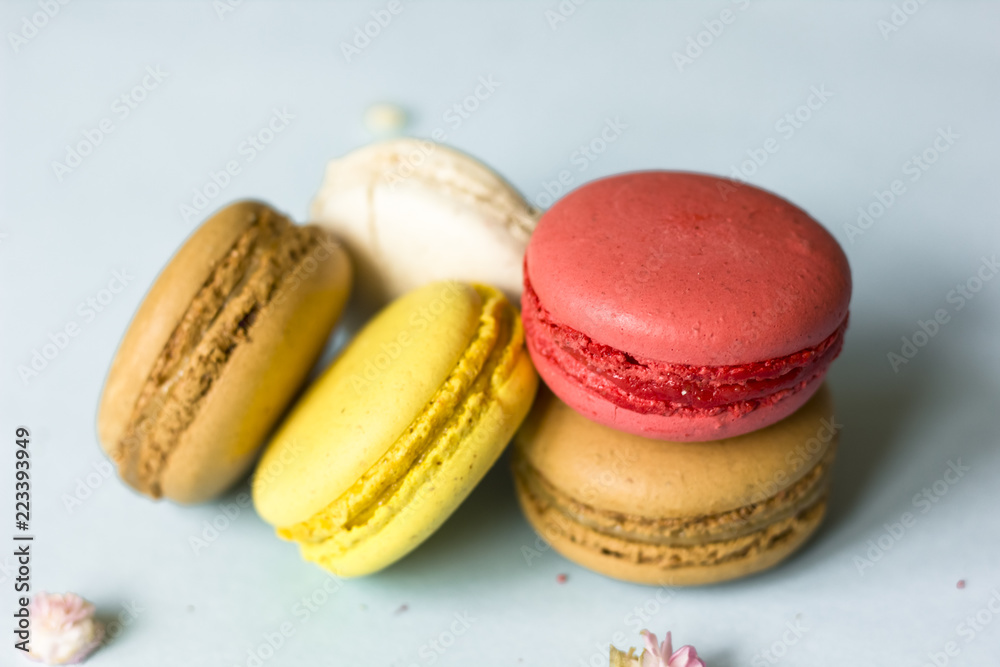Colorful french macaroons on the blue table Colorful french macaroons on the blue table