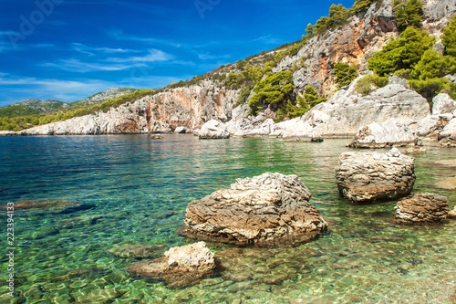 Croatian rocky coastline. Coast of Hvar Island. Greetings from the sea. Sea and rocks in Croatia. Vacation at sea. Quiet place.
