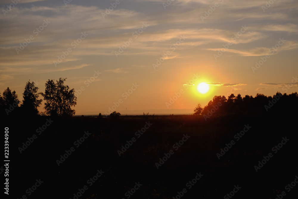 Simple and uncomplicated landscape at sunset in orange tones